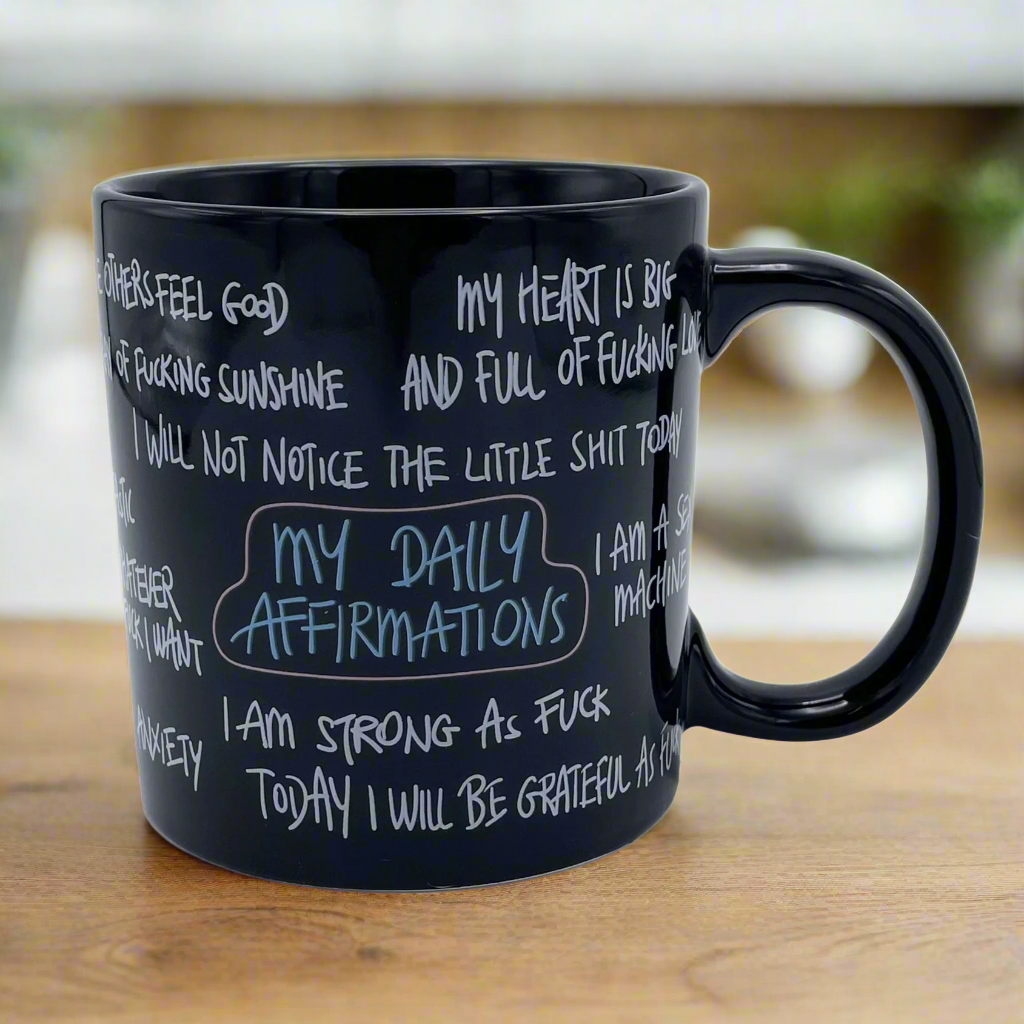 giant black mug with daily affirmations in a hand written font