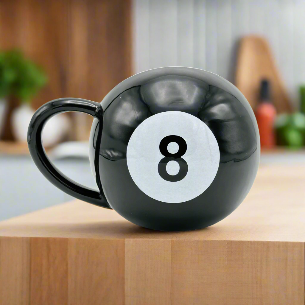 A black mug with a giant 8 ball design in white on the side.