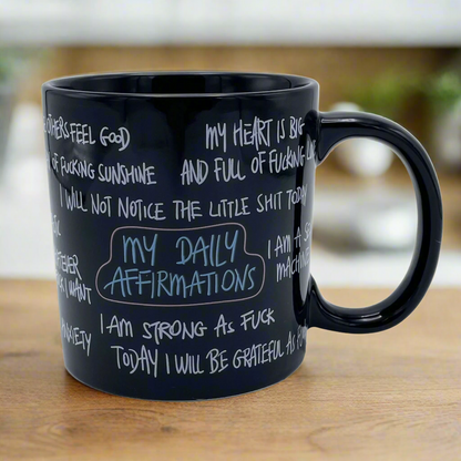 giant black mug with daily affirmations in a hand written font